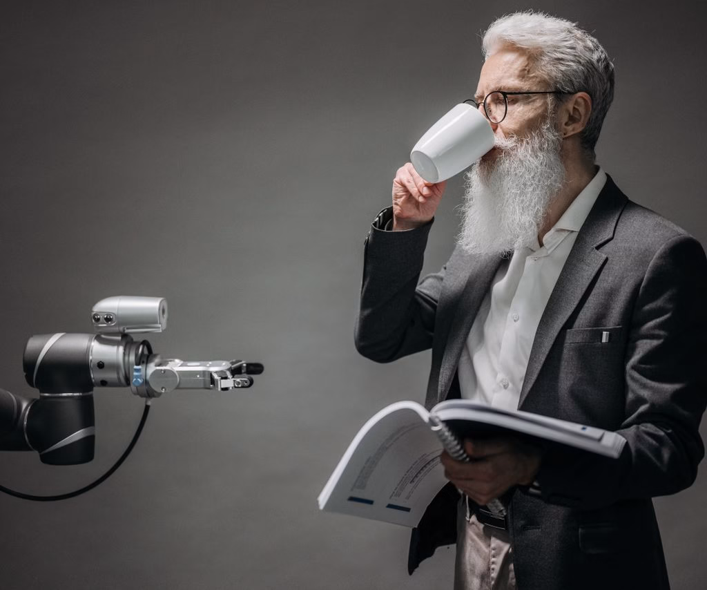 A senior man interacts with a robot while holding a book, symbolizing technology and innovation.
